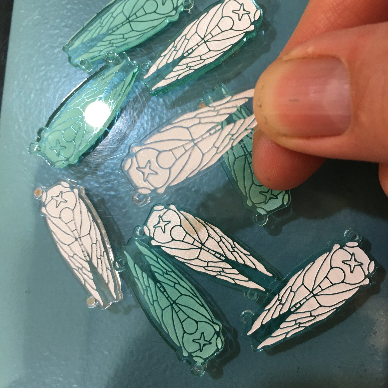 Designing earrings and necklaces with periodical cicada patterns.