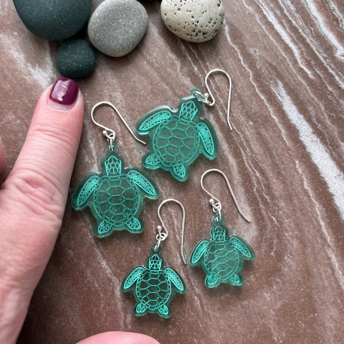 Sea turtle earnings shaped earrings, Large size, lightweight green acrylic, laser cut with sterling silver ear wires. Shown in a group to indicate size and scale