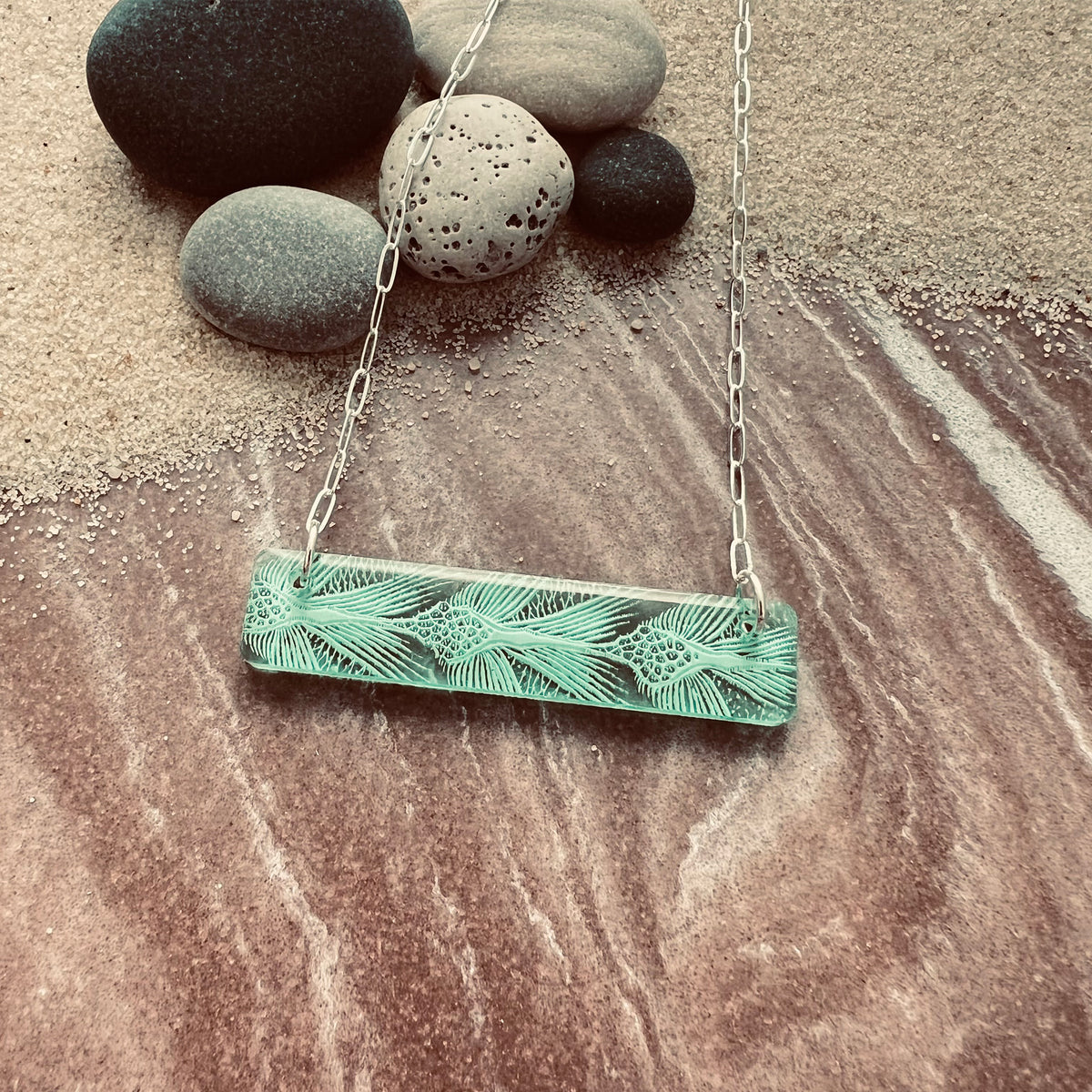 Detail of Bar Necklaces with sea turtle pattern in green