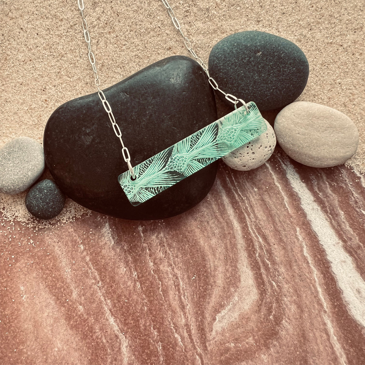 Detail of Bar Necklaces with sea turtle pattern in green