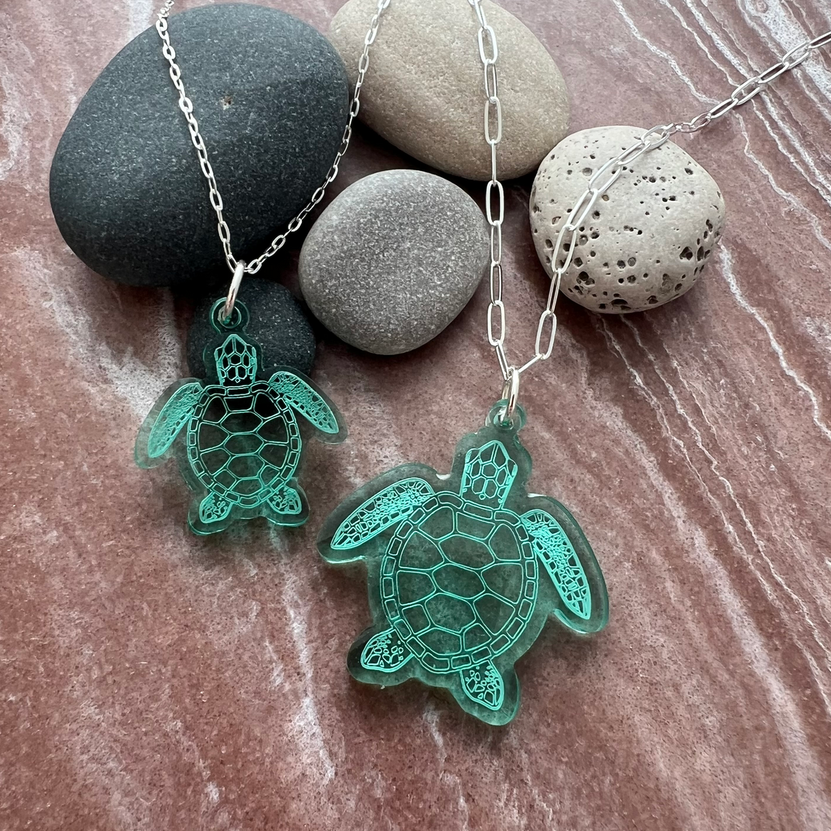 Set of 2 sea turtle pendants on a sterling silver chains. Lightweight, Semi-transparent green laser cut acrylic. Lovely to wear to any occasion. 