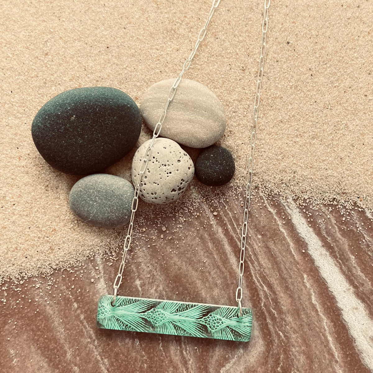 Detail of Bar Necklaces with sea turtle pattern in green